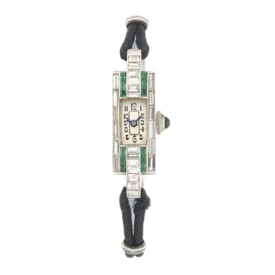 Lot 179 - A white metal diamond and emerald set cocktail watch