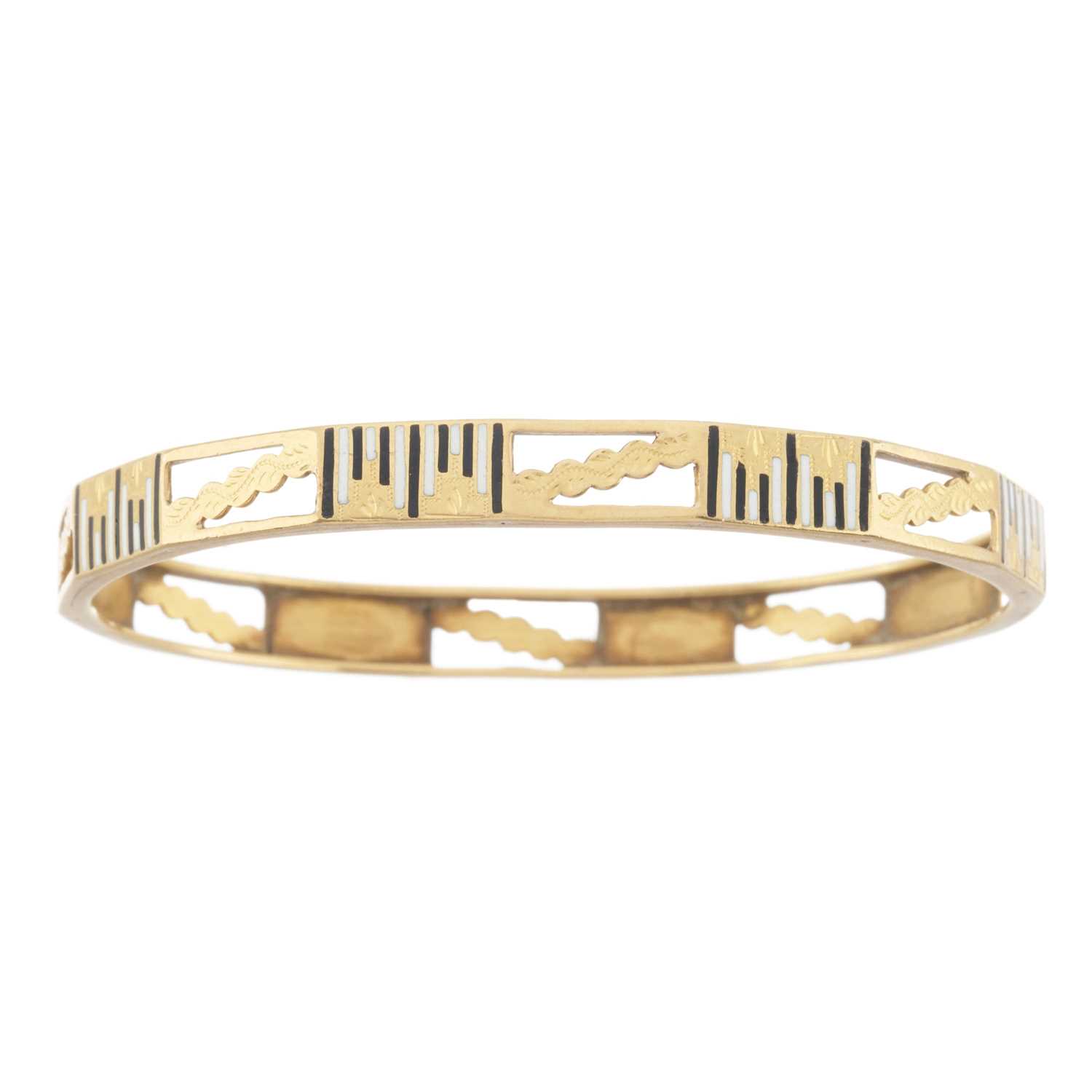 Lot 19 - An early 20th century gold, black and white enamel bangle bracelet