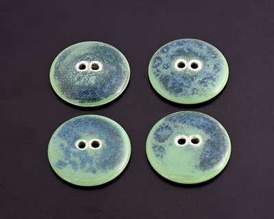 Lot 598 - Ruskin Pottery, a set of four Souffle glazed...