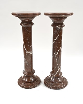 Lot 410 - A pair of variegated red and white marble...