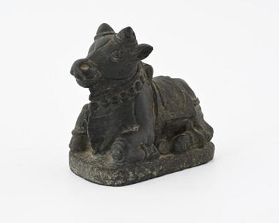 Lot 381 - An Indian carved black basalt figure of Nandi...