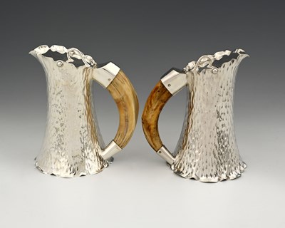 Lot 811 - Hukin and Heath, a pair of plated pitchers,...
