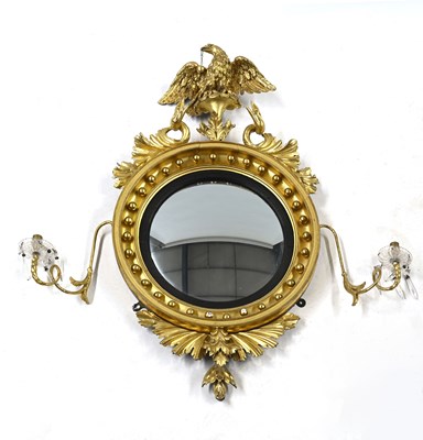 Lot 414 - A Regency giltwood twin-light convex girandole,...