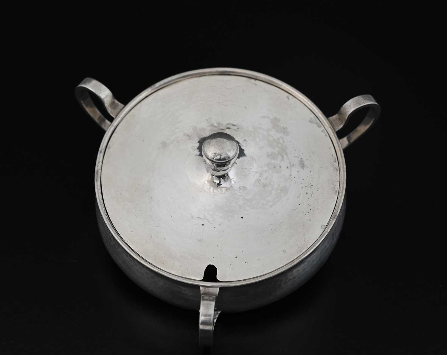 Lot 87 - A E Jones, an Arts and Crafts silver three...