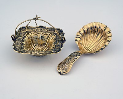 Lot 133 - A French silver-gilt tea strainer and caddy...