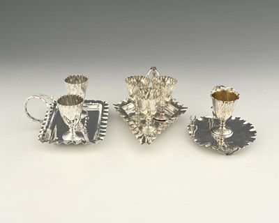 Lot 749 - Hukin and Heath, three electroplated egg cup...