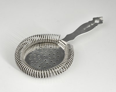 Lot 166 - A silver cocktail strainer, circular with a...
