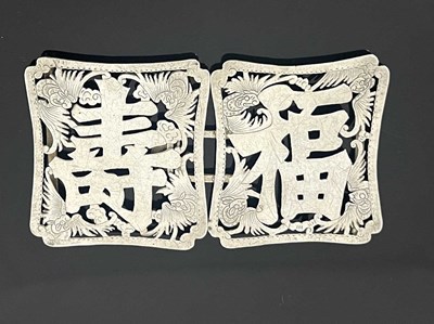 Lot 83 - A Chinese silver buckle, each shaped...