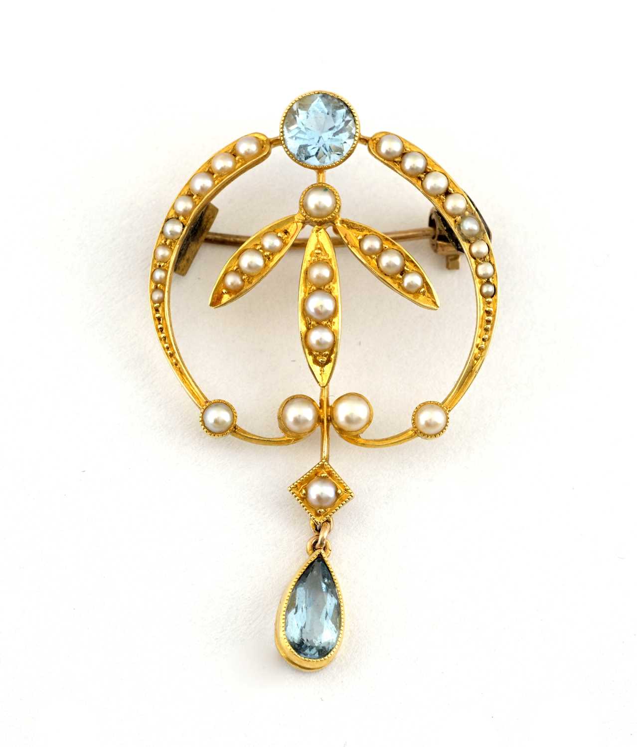 Lot 10 - An Art Nouveau gold aquamarine and split pearl foliate brooch