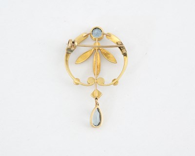 Lot 10 - An Art Nouveau gold aquamarine and split pearl foliate brooch