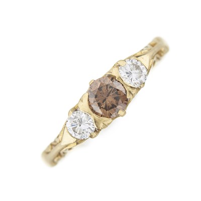 Lot 146 - An 18ct gold brown diamond and diamond three-stone ring