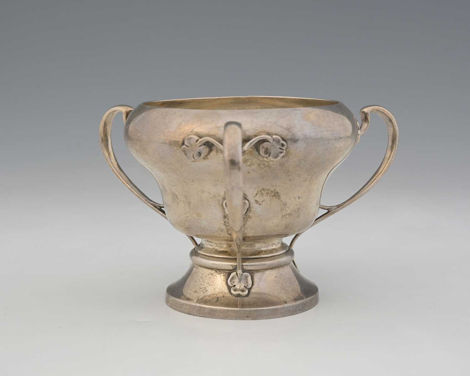 Lot 51 - An Arts and Crafts silver three handled vase,...