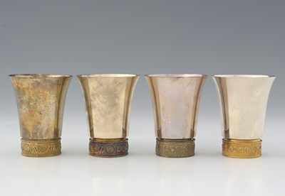 Lot 395 - A set of four silver and parcel-gilt beakers,...