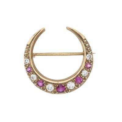 Lot 14 - A gold ruby and diamond crescent brooch