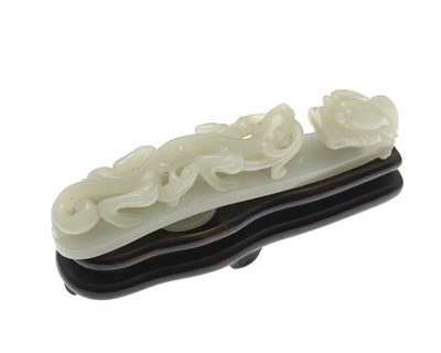 Lot 373 - A Chinese carved jade belt hook, modelled in...