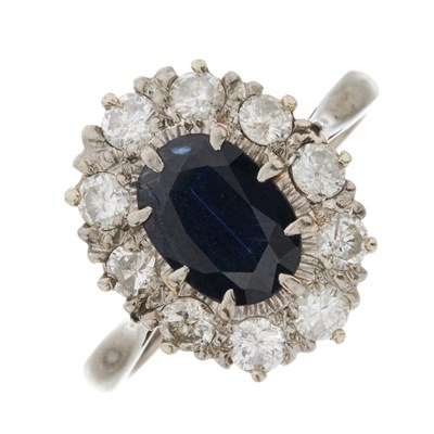 Lot 73 - An 18ct gold sapphire and diamond cluster ring
