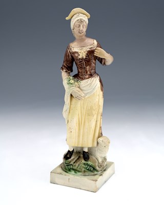 Lot 829 - A Staffordshire figure of a shepherdess with...