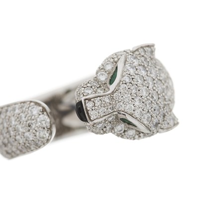 Lot 63 - Cartier, an 18ct white gold diamond, emerald and onyx Panthere de Cartier ring