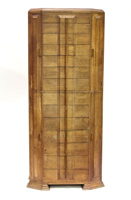 Lot 396 - A tall oak music cabinet in the manner of Heal'...