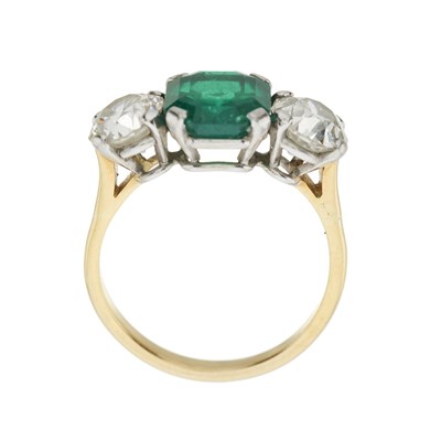 Lot 64 - An emerald and brilliant-cut diamond three-stone ring, with report