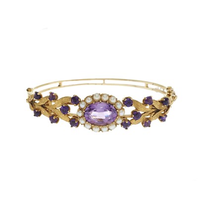 Lot 147 - A 9ct gold amethyst and split pearl bangle