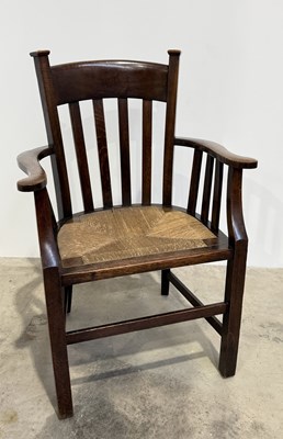Lot 667 - An Arts and Crafts oak and rush seated chair...
