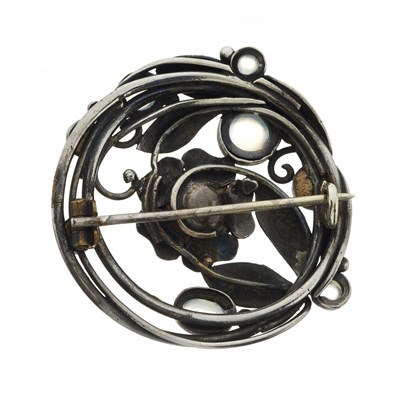 Lot 71 - An Arts and Crafts silver moonstone floral brooch
