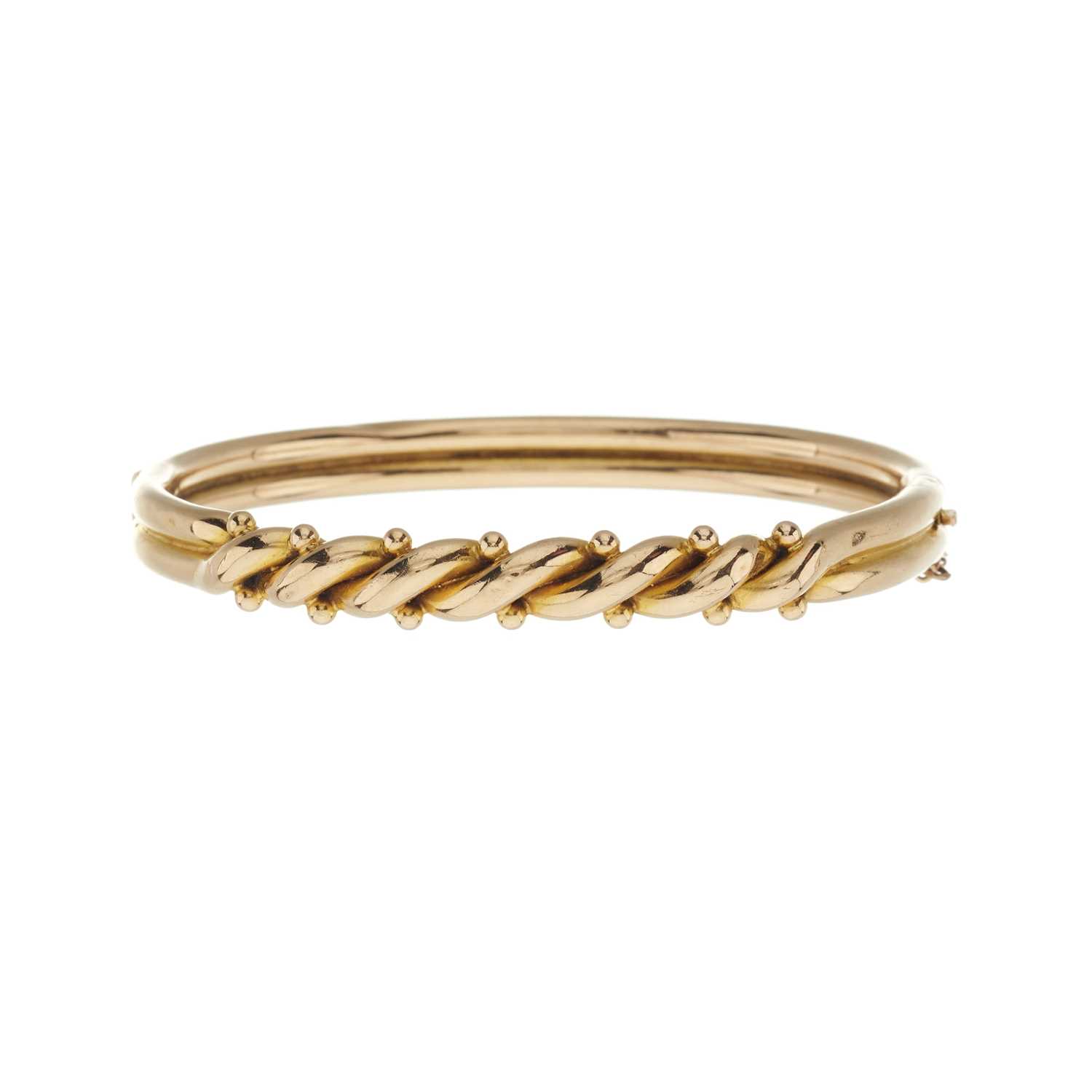 Lot 22 - An early 20th century 15ct gold twist and bead hinged bangle