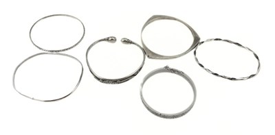Lot 398 - Six white metal bangles