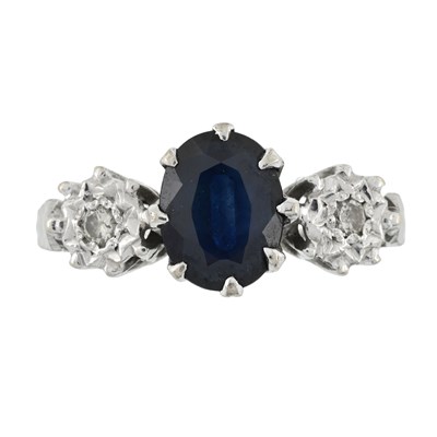 Lot 539 - An 18ct gold sapphire and brilliant-cut diamond three stone ring
