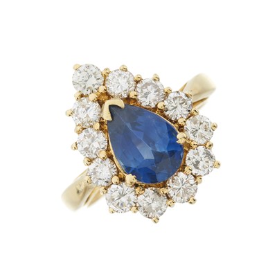 Lot 97 - A pear-shape sapphire and brilliant-cut diamond cluster ring