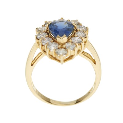 Lot 97 - A pear-shape sapphire and brilliant-cut diamond cluster ring