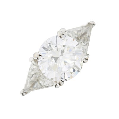 Lot 226 - A circular shape cubic zirconia and triangular shape diamond three-stone ring