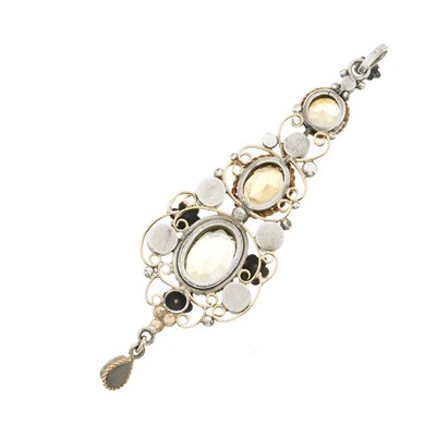 Lot 34 - An Arts & Crafts gold and silver citrine and garnet scrolling floral pendant