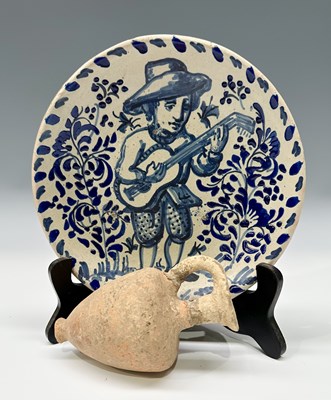 Lot 142 - A Delft-type faience plate and stand, painted...