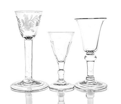 Lot 692 - Three plain stemmed and baluster wine glasses,...