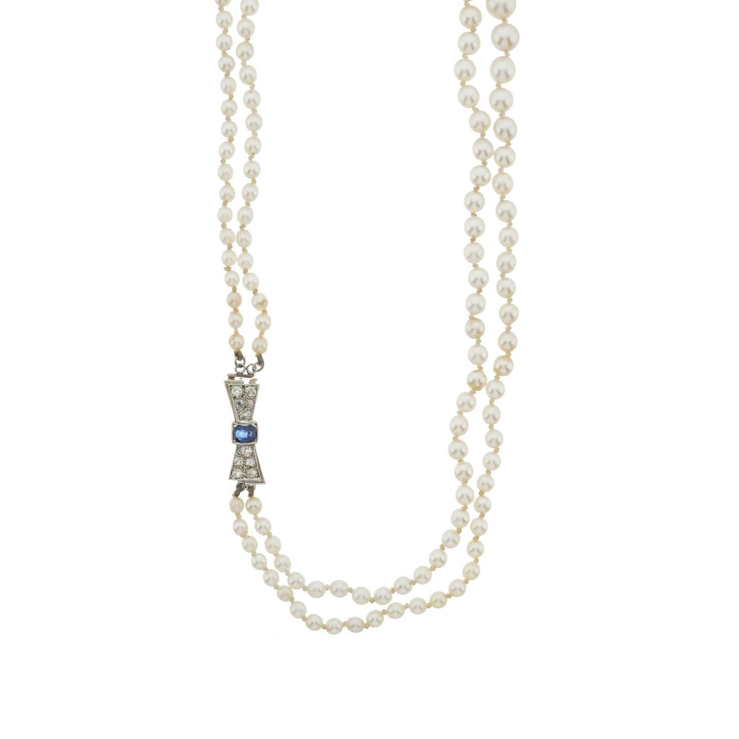 Lot 57 - A cultured pearl necklace, with sapphire and diamond clasp and a pair of earrings