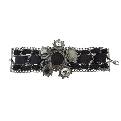 Lot 342 - Chanel, a rare black wool and gunmetal charm bracelet.