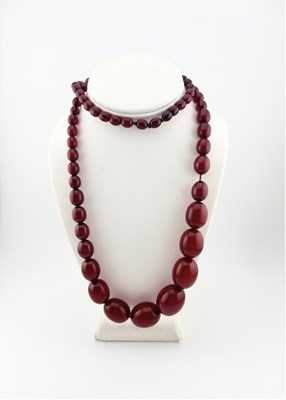 Lot 573 - A graduated cherry red bakelite bead necklace
