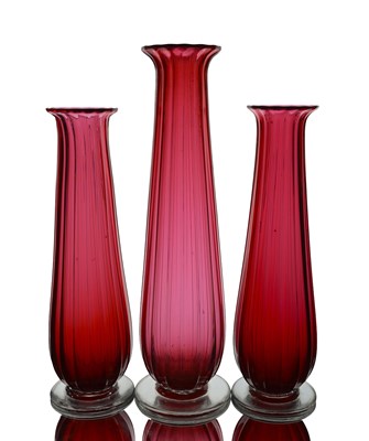 Lot 712 - A graduated trio of Kempton ruby glass vases,...