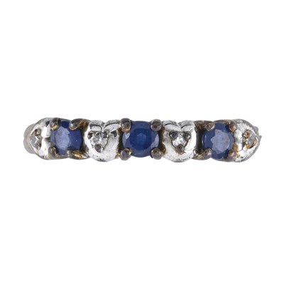 Lot 441 - A 9ct gold sapphire and brilliant-cut diamond seven stone ring