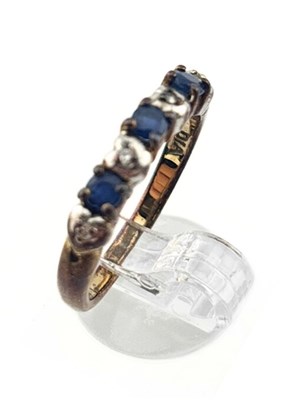 Lot 482 - A 9ct gold sapphire and brilliant-cut diamond seven stone ring