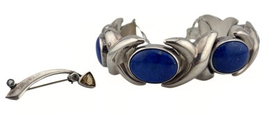 Lot 386 - A citrine and aquamarine bar brooch by Kit Heath and a silver lapis lazuli bracelet