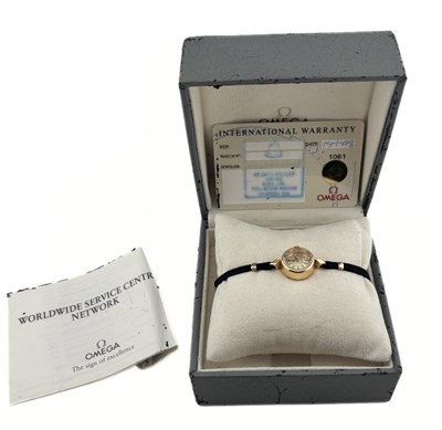 Lot 589 - An Omega ladys wrist watch, with black cord strap, with case