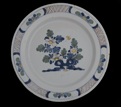 Lot 742 - A Delft polychrome dish, circa 1760, peony...