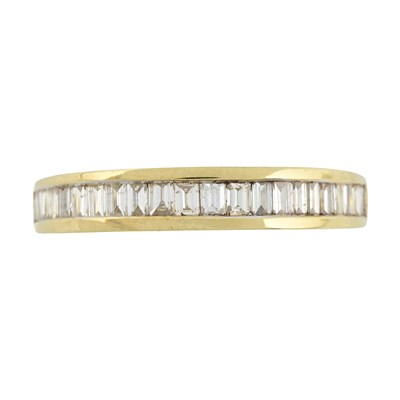 Lot 516 - An 18ct gold baguette-cut diamond half eternity ring