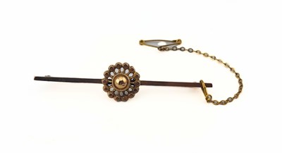 Lot 441 - An early 20th century 9ct gold bar brooch, with central domed wheel