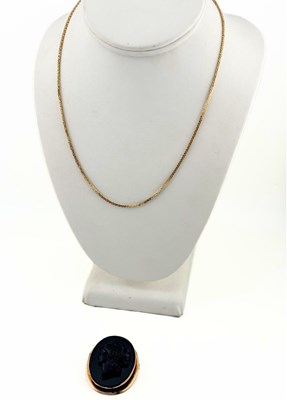 Lot 421 - An early 20th century black paste cameo brooch (AF), with a later 9ct gold chain necklace
