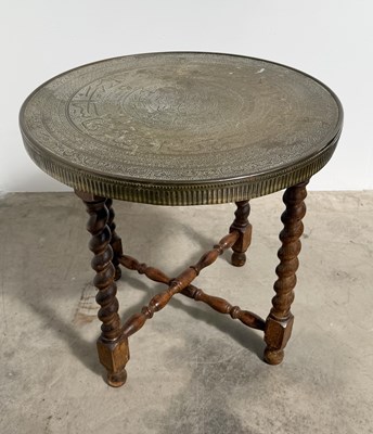 Lot 831 - An Islamic brass tray table on oak legs, a...