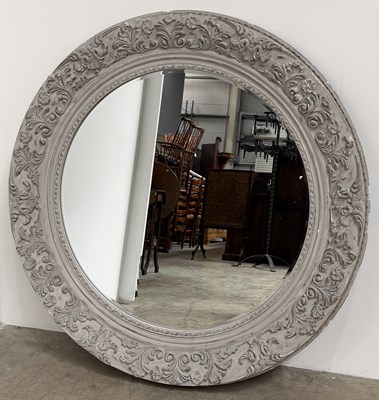 Lot 835 - A large carved wooden circular mirror with...